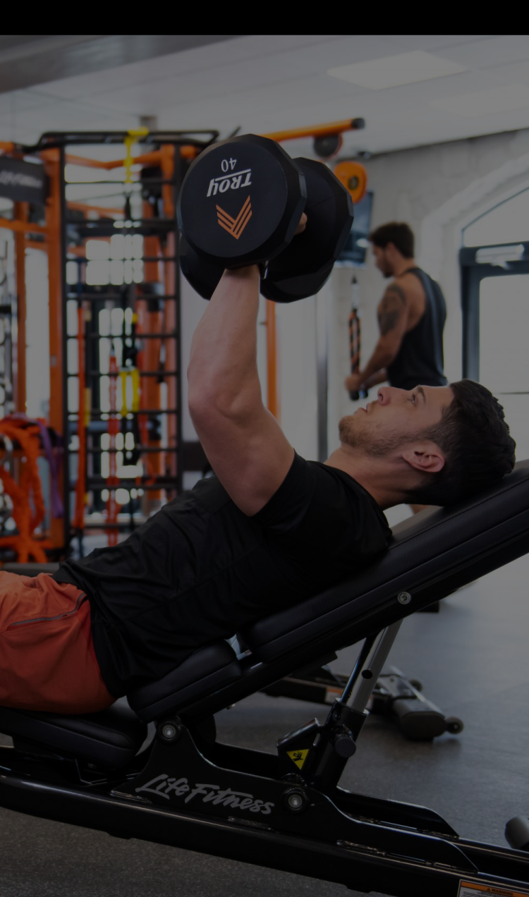 A client benches free weights at the APN Lodge gym.